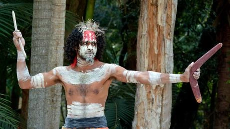 Aboriginal man with boomerang and spear